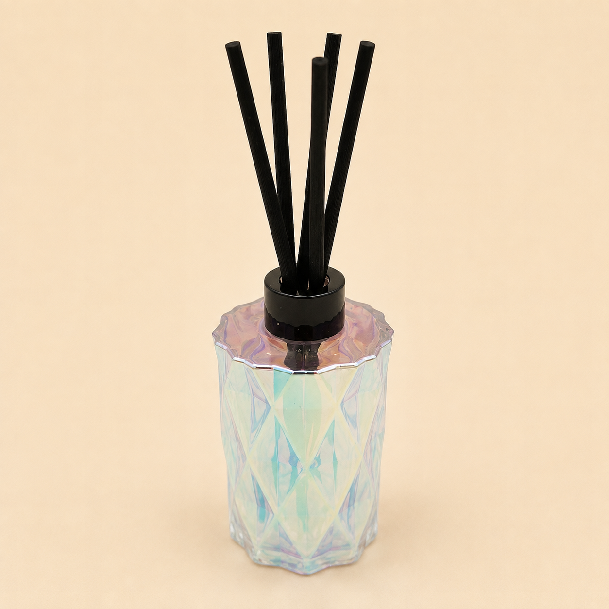 Iridescent Reed Diffuser with black reed sticks in a diamond-cut iridescent glass vessel